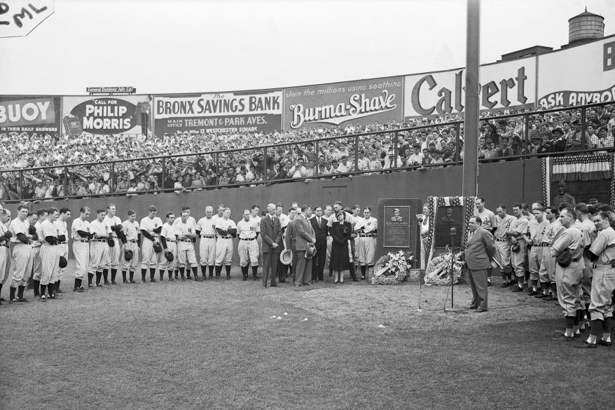 Mayor LaGuardia speaks into the microphone in praise of Lou Gehrig, the late first baseman of the new York Yankees at ceremonies today during which a monument was unveiled in honor of the slugging first baseman and long-time playing captain of the team.