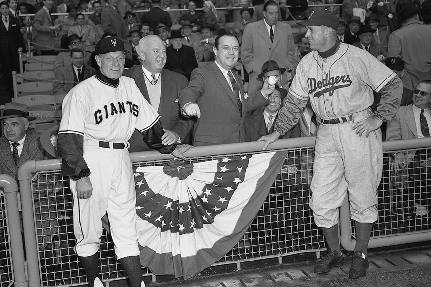 Manager Leo Durocher, of the New York Giants, National League President Warren Giles, New York City Mayor Robert Wagner, Jr., and manager Walt Alston, of the Brooklyn Dodgers, pose for a portrait as Mayor Wagner prepares to throw out the ceremonial first pitch prior to the Opening Day game on April 14, 1955 at the Polo Grounds in New York, New York.