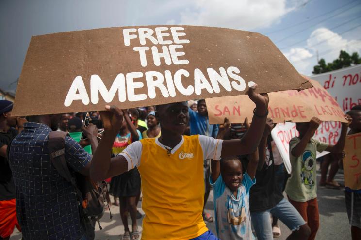 People protest for the release of kidnapped missionaries near the Ohio-based Christian Aid Ministries headquarters in Titanyen, north of Port-au-Prince, Haiti.