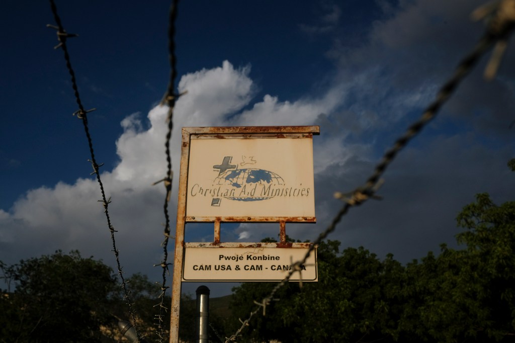 A custom sign stands outside Christian Aid Ministries in Titanyen.