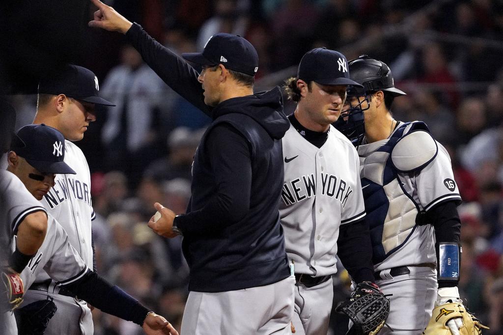 New York Yankees manager Aaron Boone (17) takes the ball from New York Yankees starting pitcher Gerrit Cole (45) during the third inning. The Boston Red Sox host the New York Yankees in the American League Wild Card Playoff Game at Fenway Park in Boston on Oct. 5, 2021.