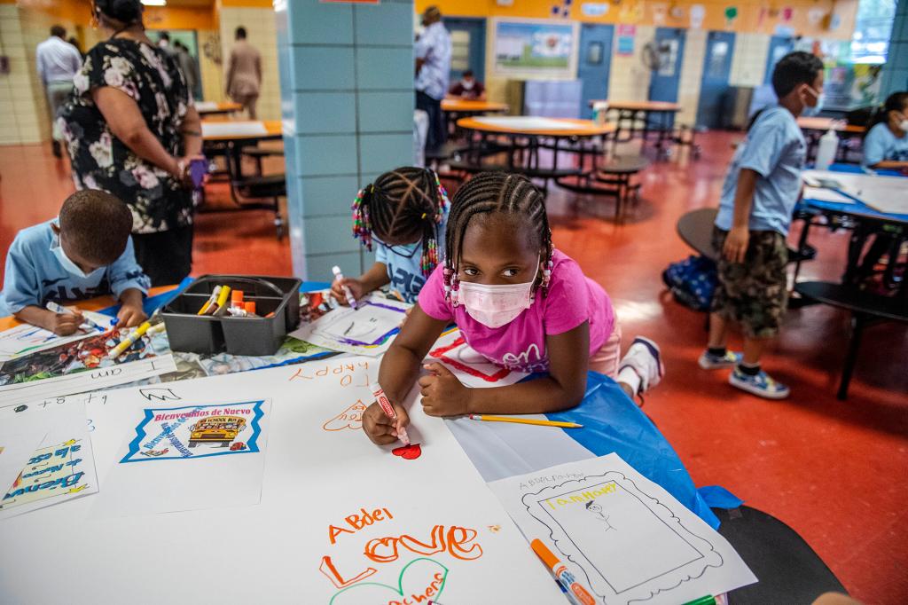 students write and draw positive affirmations on poster board at P.S. 5 Port Morris, an elementary school in The Bronx borough of New York.