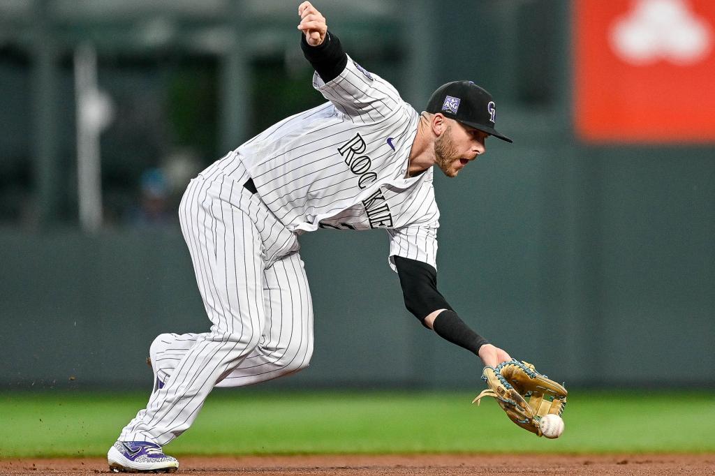 Colorado Rockies shortstop Trevor Story (27) fields a ground ball in the first inning during a game between the Colorado Rockies and the Washington Nationals at Coors Field in Denver, Colorado on September 27, 2021.