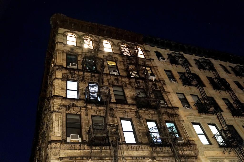 general view of apartment buildings at night in the Lower East Side section of New York, NY