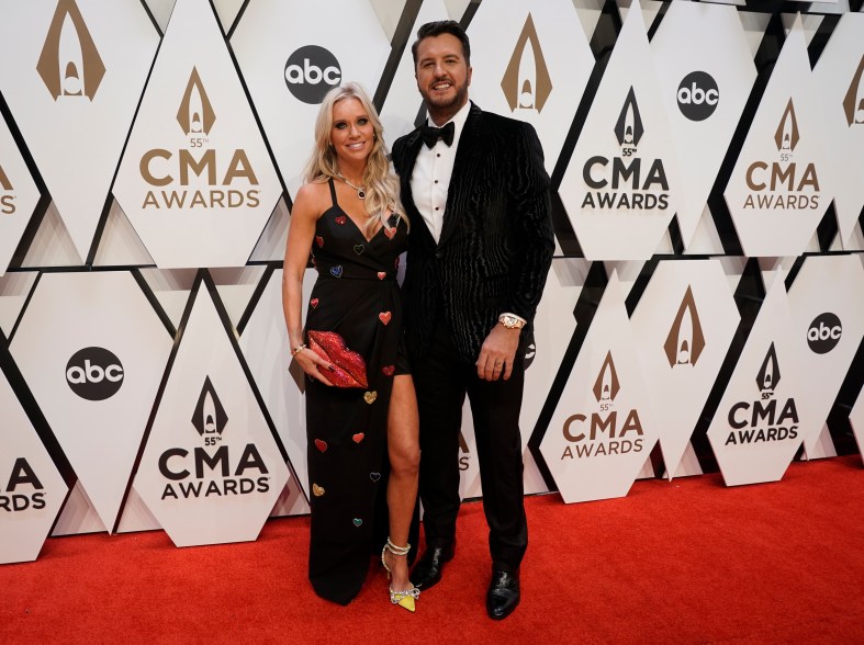 Luke Bryan, right, and Caroline Boyer arrive at the 55th annual CMA Awards.