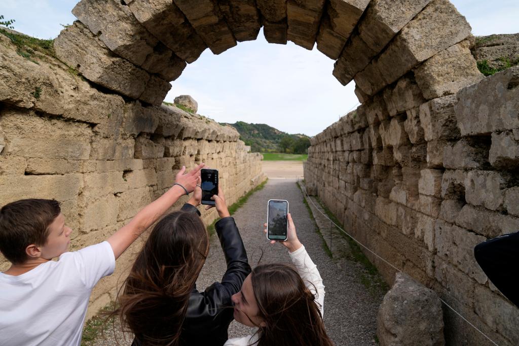 School students use a mobile app at the ancient site of Olympia, southwestern Greece, Wednesday, Nov. 10, 2021.