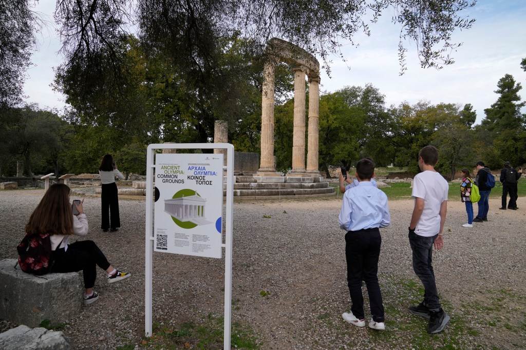 School students use a mobile app at the ancient site of Olympia, southwestern Greece, Wednesday, Nov. 10, 2021.