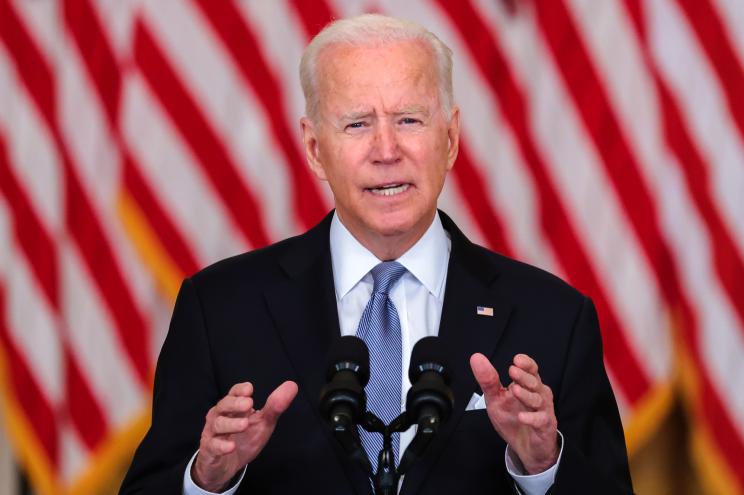 President Biden in front of an American flag.