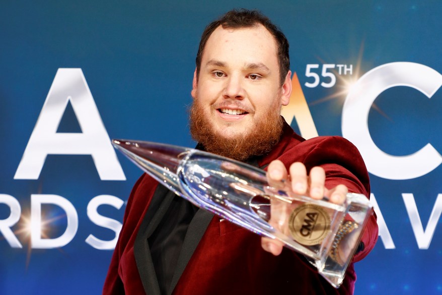 Luke Combs poses with his award for Entertainer of the Year.