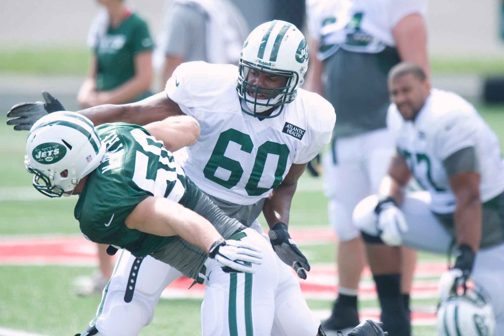 Jets tackle D'Brickashaw Ferguson #60 runs through a drill during the days practice.