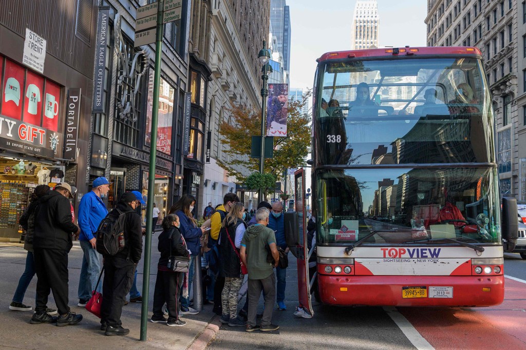 New York City tourists board a double decker bus