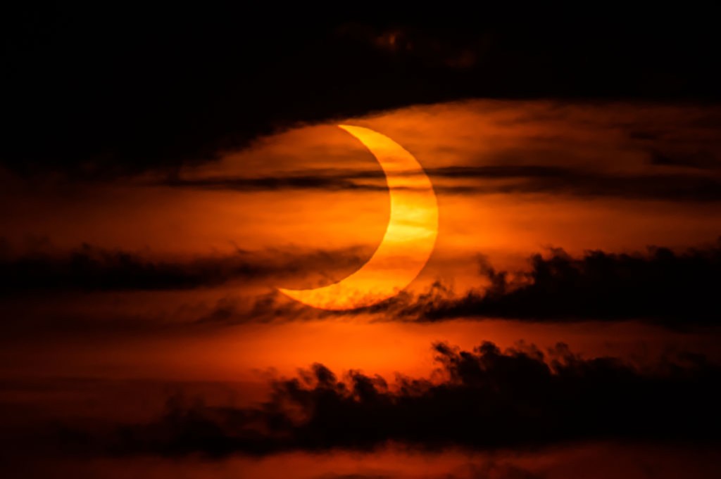 The sun rises over New York City during a solar eclipse — a rare eclipsed sunrise, at that — on June 10, 2021, as seen from The Edge observatory deck at The Hudson Yards. 