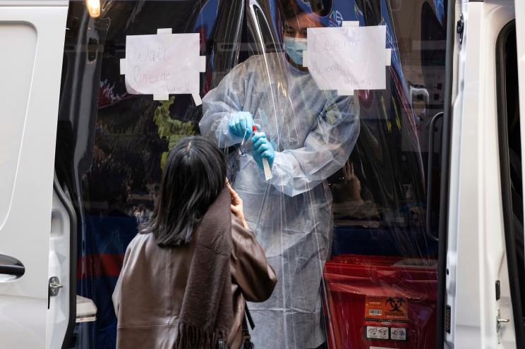 A person takes a COVID-19 test at a mobile testing site near Grand Central Terminal.