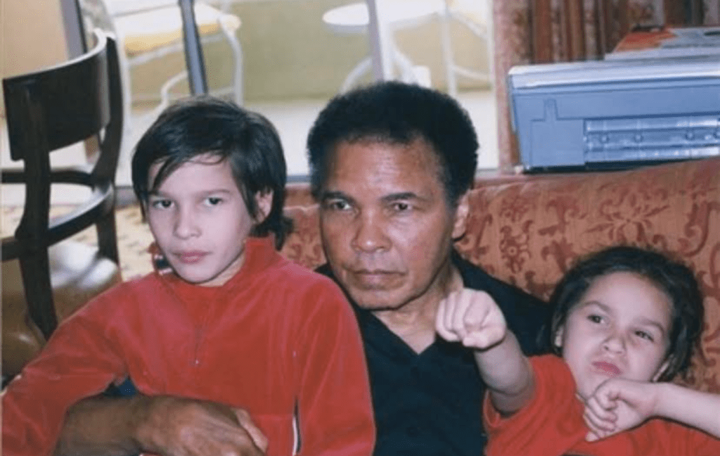 Muhammad Ali embraces Nico Ali Walsh (right) and his brother Biaggio (left).