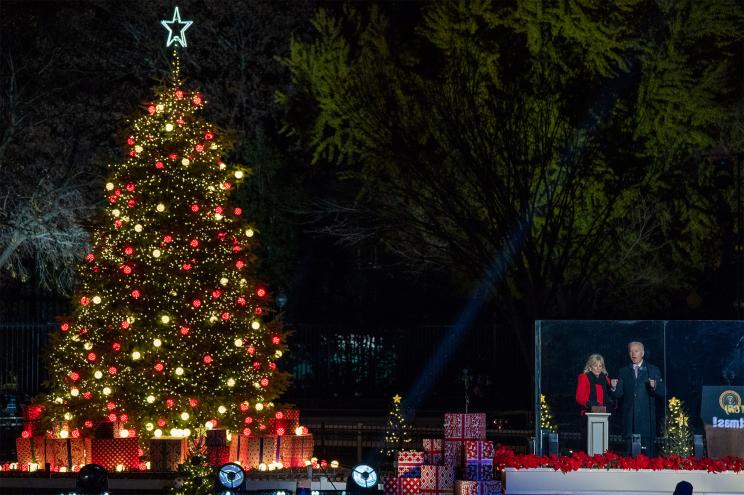 President Joe Biden, with First Lady Jill Biden, lights the National Christmas Tree during the 2021 National Christmas Tree lighting ceremony