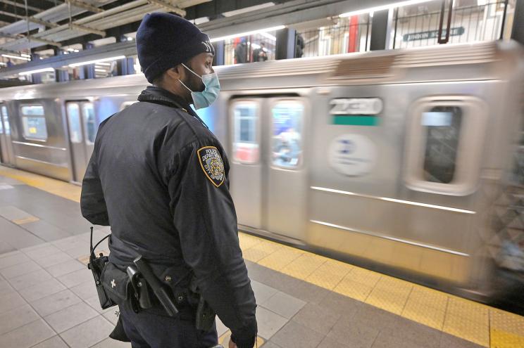 An NYPD officer is seen on the downtown subway platform at the Union Square subway station in Manhattan.