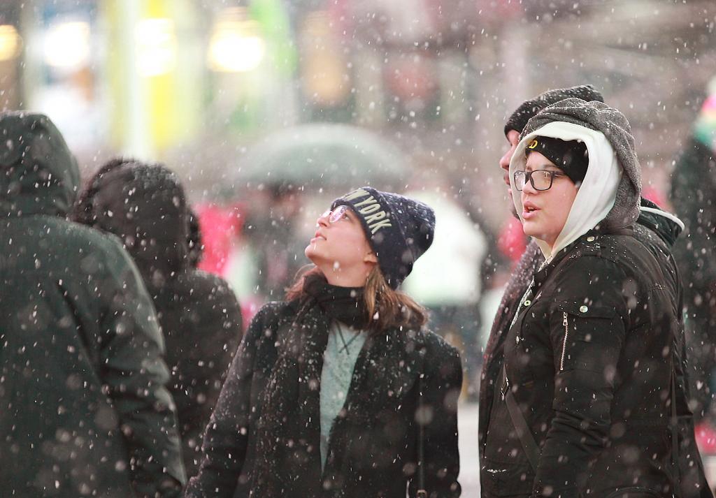 Times Square Plaza Near 46th Street and 7th Avenue where lite-snow is coming down.