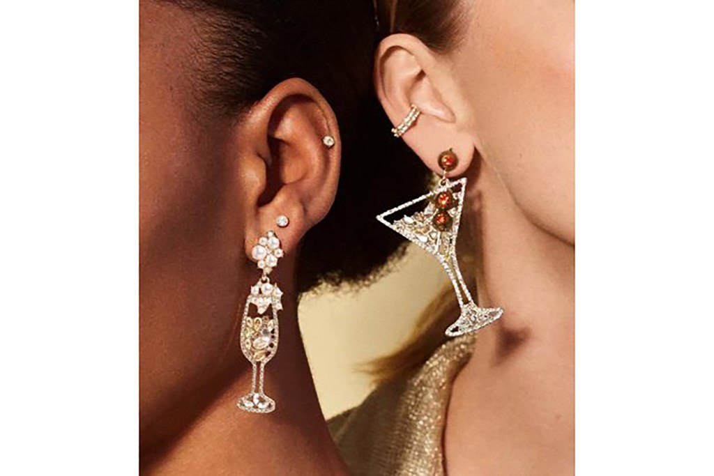 Two women's ears with dangle earrings shaped like cocktails 