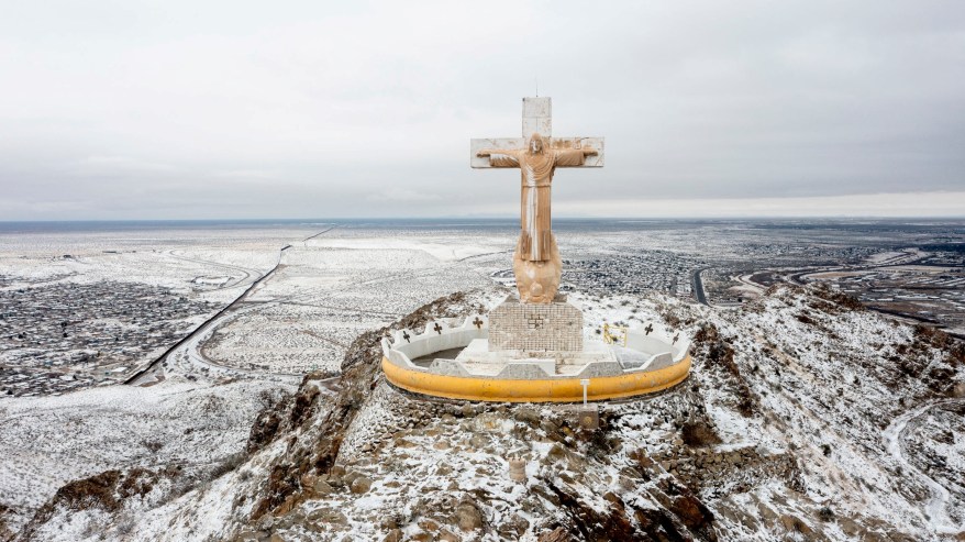 Snow covers a 29-foot tall limestone statue of Christ at the summit of Mount Cristo Rey after a snowstorm in Sunland Park, New Mexico, slammed the city on February 3, 2022.