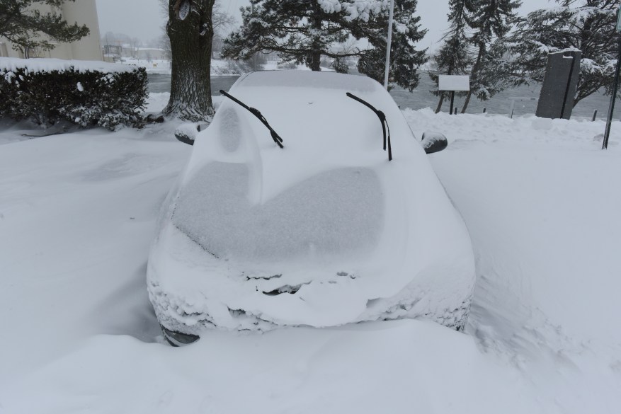 A car remains buried under several inches of snow in St. Joseph, Michigan on February 2, 2022, after a winter storm moved through Southwest Michigan.