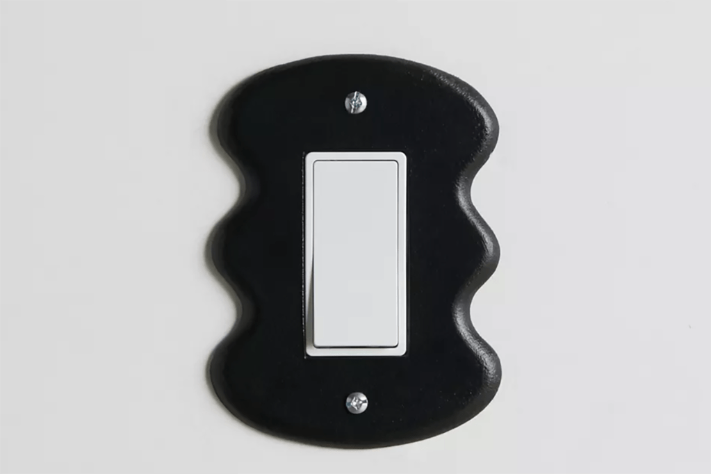 A black wavy outlet cover