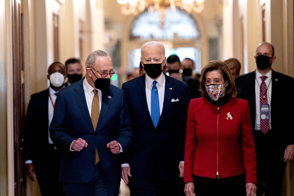 President Joe Biden (C). with Speaker of the House Nancy Pelosi (R) and Senate Majority Leader Chuck Schumer, arrives at the US Capitol on January 6, 2022