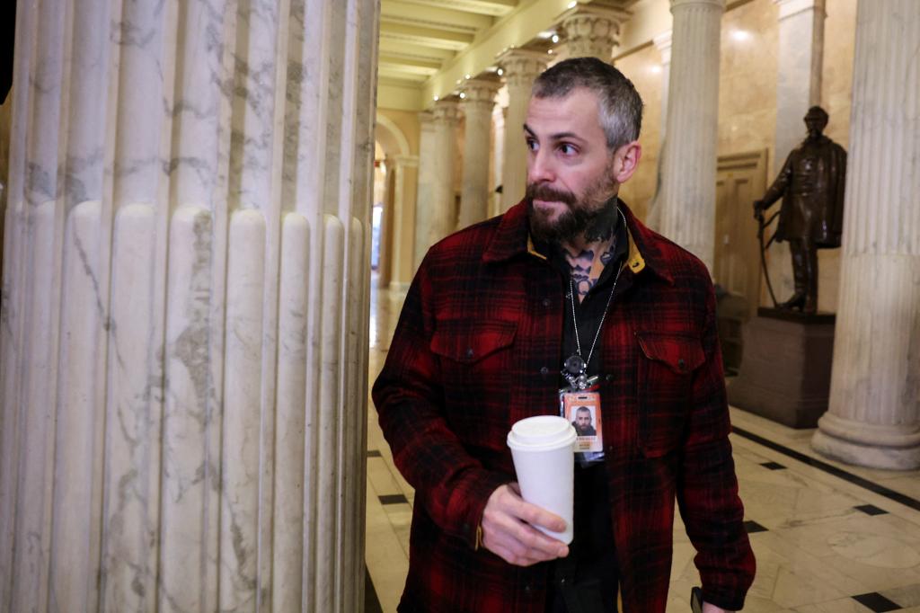 DC Metropolitan Police Department officer Michael Fanone arrives in the Hall of Columns on the first anniversary of the Capitol riot.