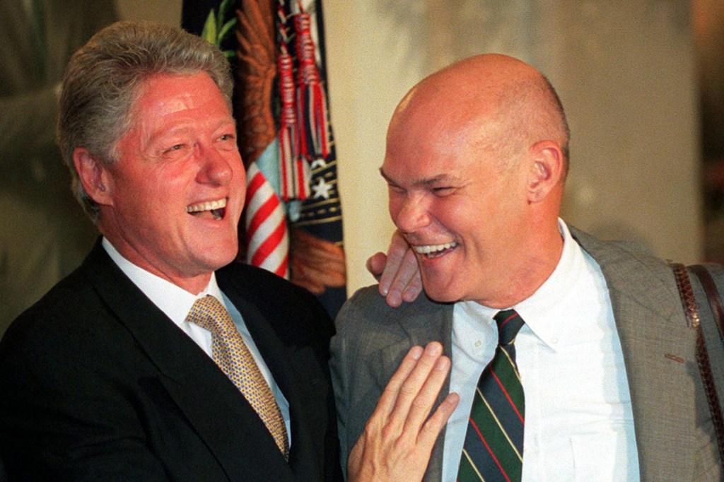 Then President Bill Clinton and strategist James Carville laugh during dinner at the White House on July 18, 1999.