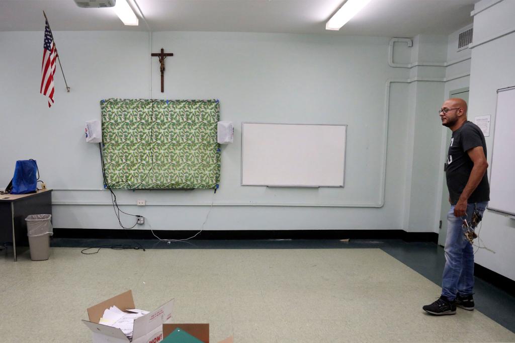 Facilities manager Charles Fabian stands in an empty classroom at Queen of the Rosary Catholic Academy in Brooklyn borough of New York.