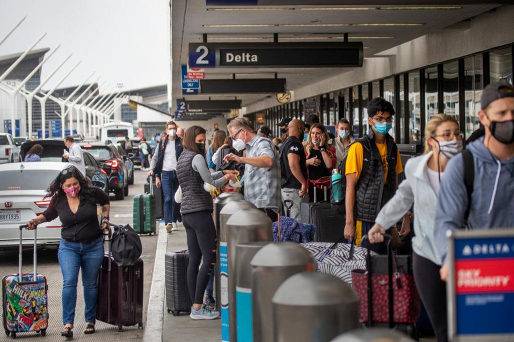 Passengers enter Delta section of airport.