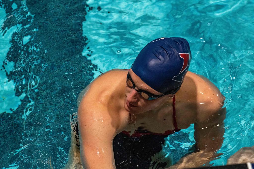 Lia Thomas, a transgender woman, holds onto the starting board as she swims for the University of Pennsylvania at an Ivy League swim meet against Harvard University in Cambridge, Massachusetts, on January 22, 2022.