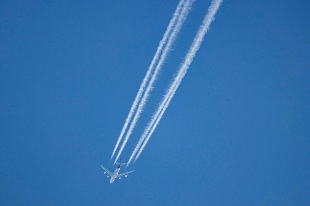 A UPS Boeing 747-8F aircraft as seen flying in the blue sky over the Netherlands.