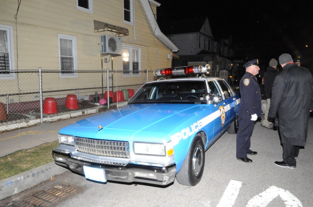 Police stand near the car honoring Edward Byrne on the corner where he was assassinated on Feb. 26, 1988.