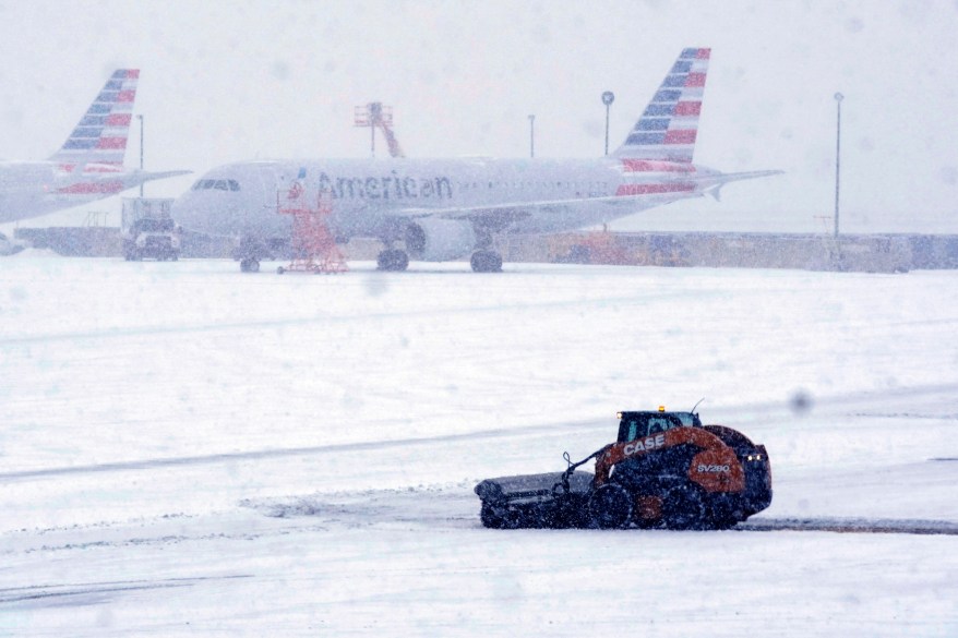 Snow and ice are cleared from the tarmac at Dallas Fort Worth International Airport in Grapevine, Texas on February 3, 2022.