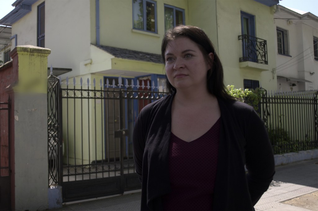 Callie Quinn stands outsider the Chile house she lived in. 