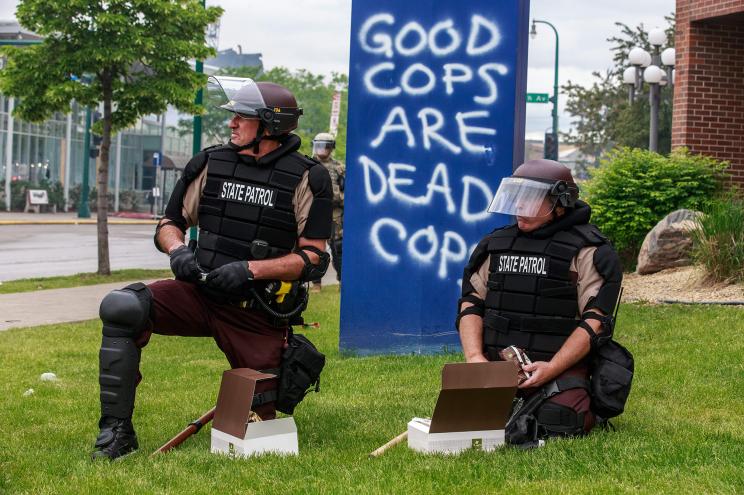 State Patrol Police officers take a break on the fourth day of protest on May 29, 2020 in Minneapolis, Minnesota.