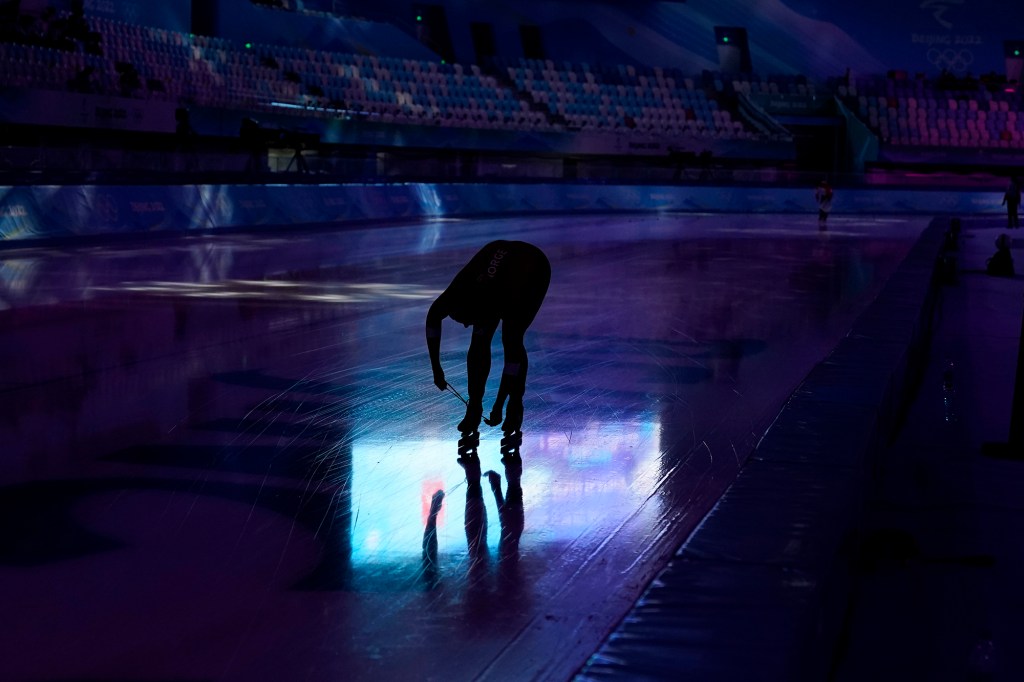 An athlete laces their skate during a speedskating practice ahead of the 2022 Winter Olympics, Wednesday, Feb. 2, 2022, in Beijing.