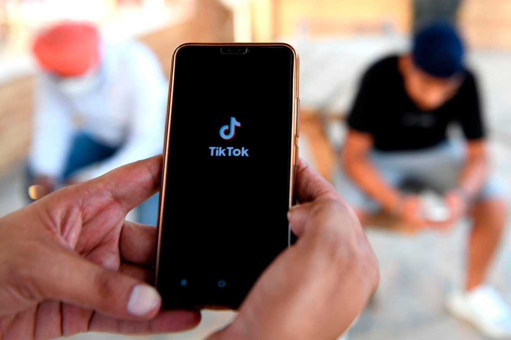 Mobile users browse through TikTok app on smartphones