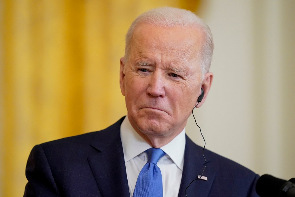 President Joe Biden listens as German Chancellor Olaf Scholz speaks during a news conference.