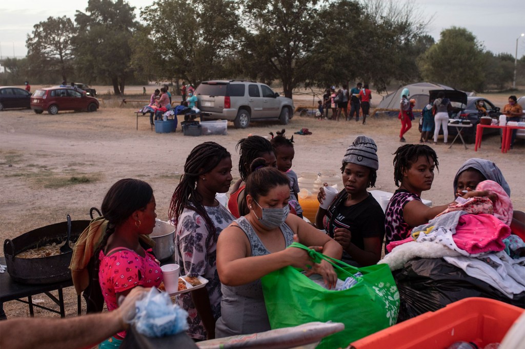 A woman distributes clothes