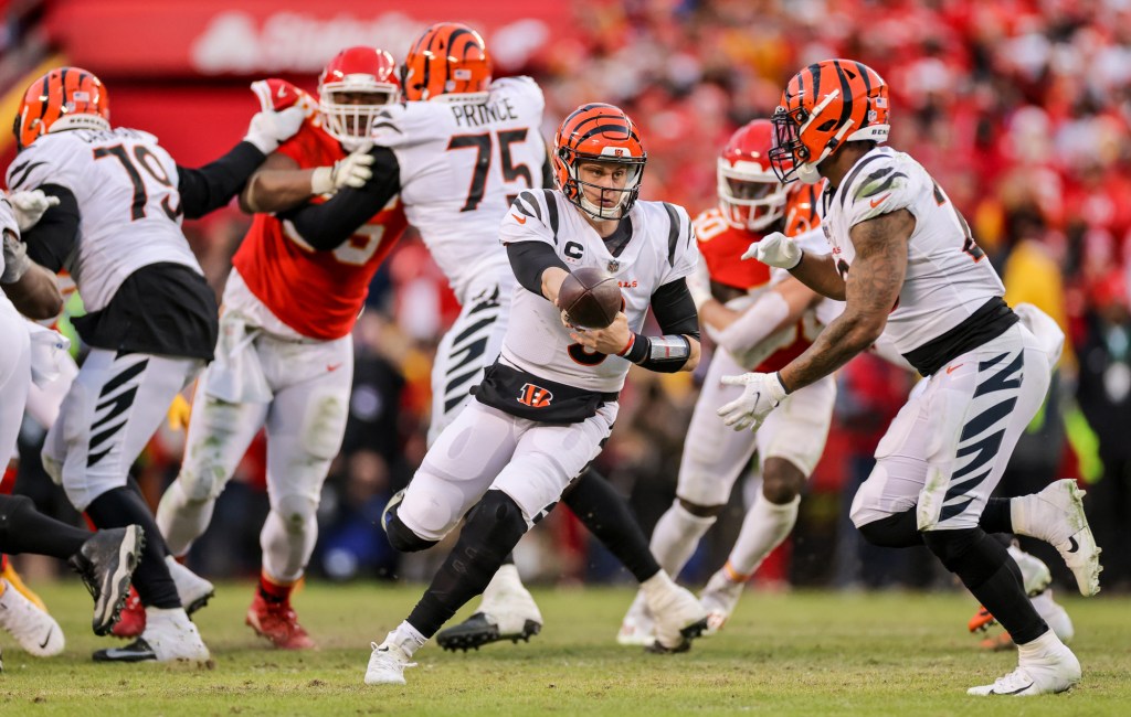 Joe Burrow hands off in the AFC Championship game. 