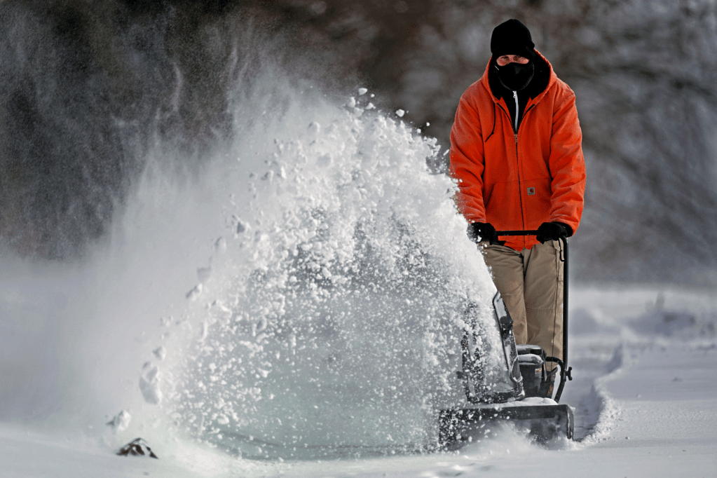 Heavy winter storm conditions called for a mix of rain, freezing rain and snow to the central U.S. on Wednesday, as officials urged residents to stay off roads.