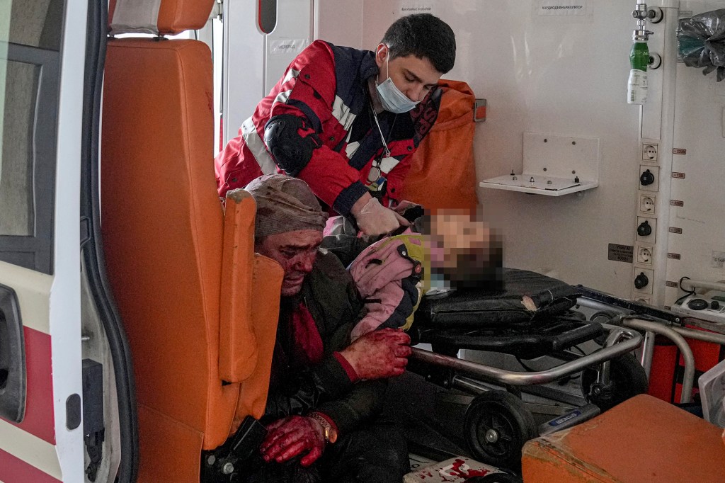 Oleksandr Konovalov, an ambulance paramedic performs CPR on a girl.