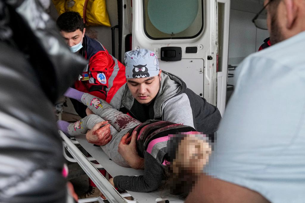 Medics transport a girl injured during shelling from an ambulance in city hospital of Mariupol, eastern Ukraine.