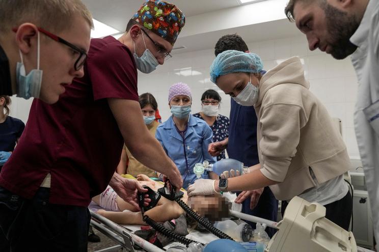 Medics perform CPR on a girl injured during the shelling of a residential area, in the city hospital of Mariupol, eastern Ukraine.