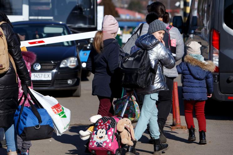 A woman and children are pictured at the Uzhhorod-Vysne Nemecke checkpoint on the Ukraine-Slovakia border, Zakarpattia Region, western Ukraine.