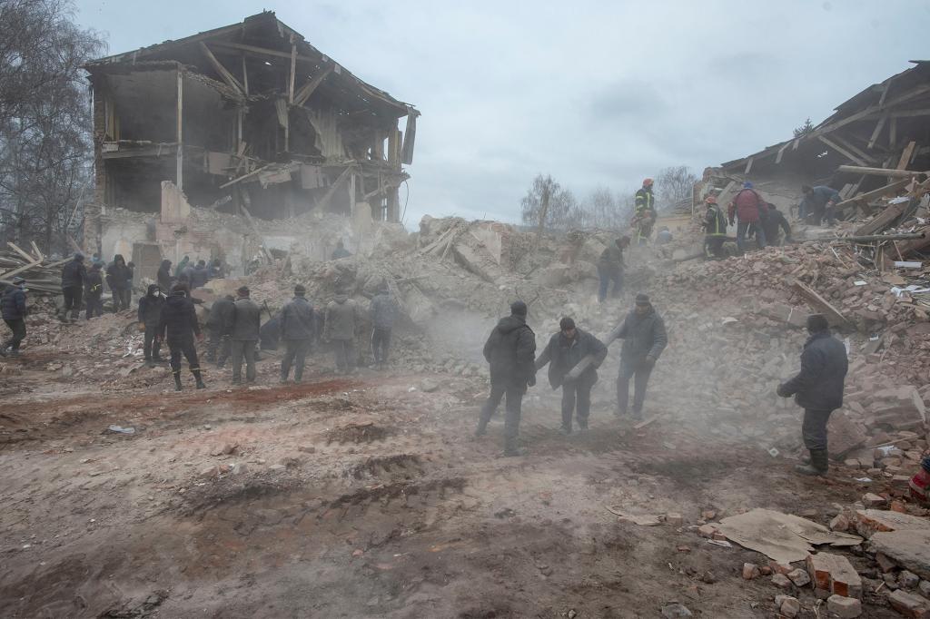 People removing debris from a military base that was hit by a Russian air strike in Okhtyrka, Ukraine on February 28, 2022.