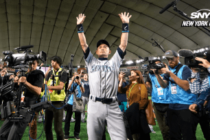 Ichiro Suzuki salutes the crowd with cameras surrounding him, after he retired from a professional baseball career.