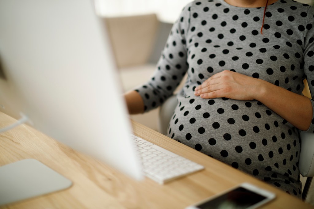 Pregnant woman in home office