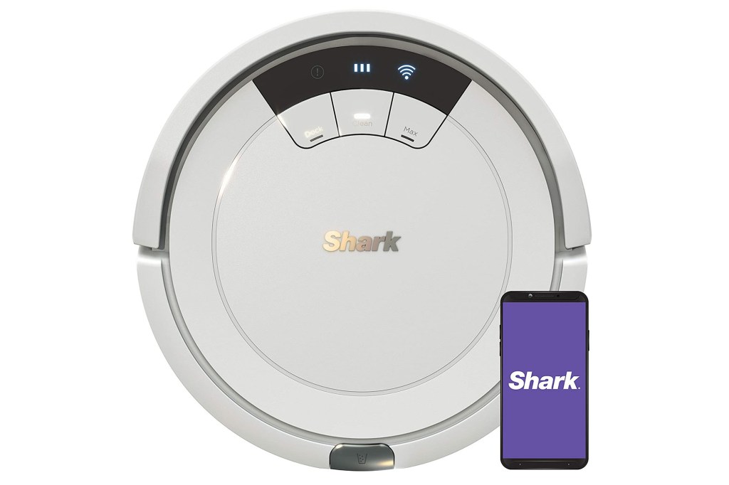 A white robot vacuum and a phone showing a purple Shark app